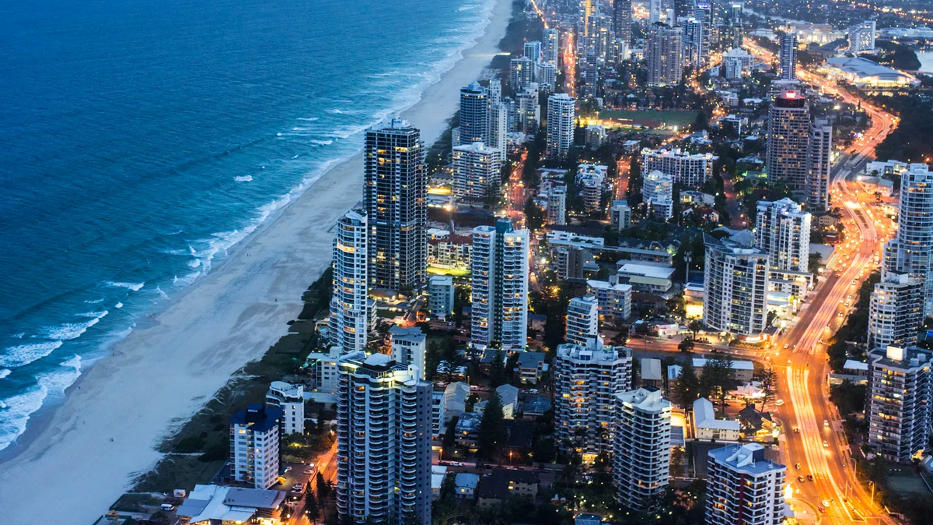 Aerial view of Gold Coast high-rises and coastline at dusk